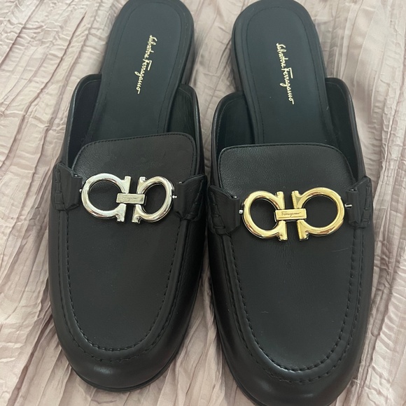 Authentic Ferragamo black leather mules with one silver one gold logo size 10